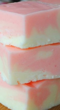 three pink and white soap bars stacked on top of each other