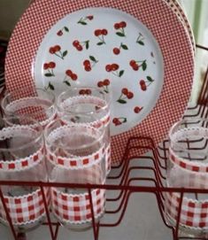 red gingham cups and plates on a rack