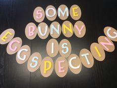 some bunny is specking spelled out on a black table with pink and yellow letters