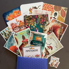 many different pictures and stickers on top of a blue envelope with the word pickers in it