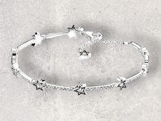 ✨ Sparkle and shine with our Shining Star Charm Bracelet! 🌟 This stunning piece features a dazzling cubic zirconia star charm on an adjustable chain, making it perfect for both women and men. Ideal for couples, this bracelet is a beautiful jewelry gift that adds a touch of elegance to any outfit. 💫🎁 Silver Star Bracelet, Star Charm Bracelet, Chain Making, Chain For Women, Star Bracelet, Shining Star, Star Charms, Silver Stars, Charm Bracelets