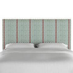 an upholstered headboard with red and green herringbones on the sides