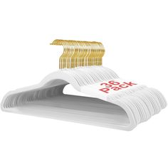 a stack of white paper with gold hair clips on the top and bottom of it