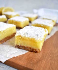 lemon bars on a cutting board with powdered sugar