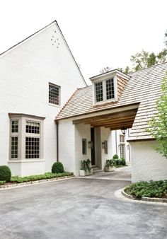 a white house with a red door and windows