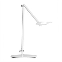 a white desk lamp sitting on top of a table