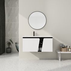 a white sink sitting under a round mirror next to a wall mounted faucet