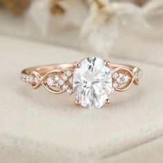 an engagement ring with a white diamond in the center and two diamonds on each side