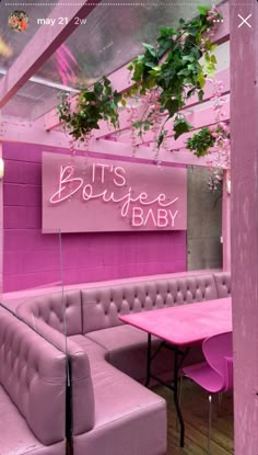 a pink booth with two couches and a sign that says it's boutique baby