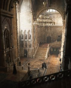 an old building with stairs and chandeliers