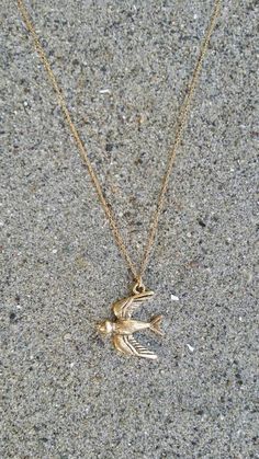 The gold plated charm is 20m x 21mm with an antiqued finish. It  has a delicate 14K gold fill chain with a gold fill clasp in back. Shown here in 17" length.Also available in silver and found here:https://www.etsy.com/listing/268534721/bird-necklace-bird-pendant-silver-bird?ref=shop_home_active_12&pro=1&frs=1*If you are unsure of the length you need, or would like to wear this item at different lengths, we now offer an adjustable length option! You can add an adjustable end to your neckl Everyday Nickel Free Brass Charm Necklaces, Everyday Brass Charm Necklace Nickel Free, Dainty Yellow Gold Brass Charm Necklace, Vintage Recycled Gold Jewelry As A Gift, Vintage Recycled Gold Jewelry Gift, Dainty Gold Brass Charm Necklace, Gold Charm Necklace, 14k Gold Filled, Nickel Free, Dainty Brass Charm Necklace With Lobster Clasp, Antique Gold Engraved Charm Necklaces