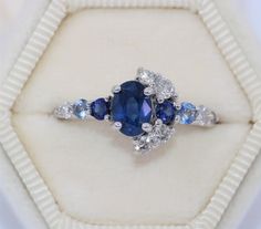 This Enchanting Ring features an oval shape 1.2 carat Blue Sapphire. Flanked by .30 carat 2 shiny deep blue sapphires, .20 carat aqua color 2 sapphires, .40 carat 7 Ice Gray Diamonds. Set in 14k white gold. Can be custom made in rose or yellow or white gold. Please choose the gold color at checkout. OOAK (one-of-a-kind) ring makes you the owner of something that nobody else has. Find your true style! Own this ring! Ethical Sourcing: This ring has a natural, ethically-sourced stones and recycled Oval Sapphire Ring Gia Certified, Heirloom Blue Sapphire Diamond Ring, Marquise Sapphire Ring In White Gold, Blue Multi-stone Sapphire Ring In Platinum, Blue Multi-stone Platinum Sapphire Ring, Oval Multi-stone Sapphire Ring In Platinum, Oval Sapphire Diamond Ring With Multi-stone, Platinum Multi-stone Blue Sapphire Ring, Oval Blue Multi-stone Sapphire Ring