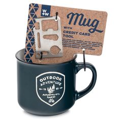 a mug with a credit card in it and a keychain attached to the cup