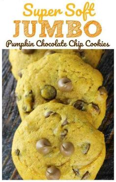 several chocolate chip cookies sitting on top of a wooden table