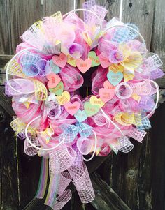 a pink wreath with hearts and words on it