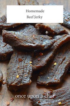 beef jerks on a wooden cutting board with the words homemade beef jerry above it