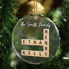 a glass ornament with scrabbles on it that says the smith family