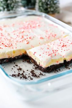 two pieces of cake with white frosting and red sprinkles