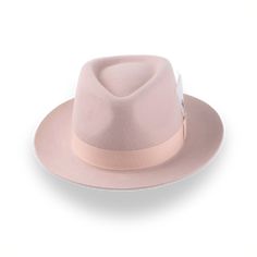 Description Materials Craftsmanship Hat Care Shipping Returns Product Description A Unique Light Pink Fedora Hat Step up your fashion game with The Clubber, a light pink fedora hat meticulously crafted from premium rabbit fur felt. This hat's smooth finish and 4 1/2" crown height offer a sleek and sophisticated look, while the 2 1/4" raw-edge upturned brim adds a unique touch of flair. The grosgrain ribbon hatband perfectly complements its stylish design, making it a standout accessory. Custom-m Pink Fedora Hat, Pink Fedora, Homburg Hat, Outdoor Hut, Gambler Hat, Mens Hats Fashion, Fedora Hat Men, Homburg, Chapeau Cowboy