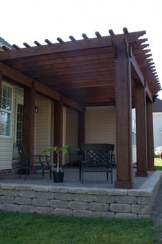 a covered patio with chairs and table on it