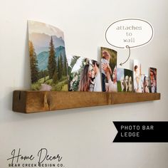 a wooden shelf with pictures on it and a thought bubble above the photo bar sign