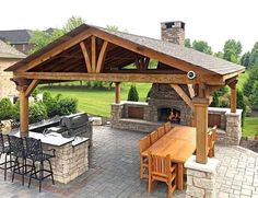 an outdoor kitchen and dining area is shown