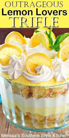 a dessert with lemons and whipped cream in a glass dish on a wooden table