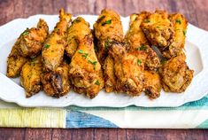 chicken wings on a white plate with parsley