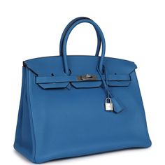 This Birkin is in Bleu Mykonos clemence leather with palladium hardware and has tonal stitching, front flap, two straps with center toggle closure, clochette with lock and two keys, and double rolled handles.The interior is lined with Bleu Mykonos chevre and has one zip pocket with an Hermes engraved zipper pull and an open pocket on the opposite side.Collection: O SquareOrigin: FranceCondition: Pre-owned; Mint - This bag retains it shape. There's no signs of wear or use on the exterior leather. There's plastic on the hardware and no signs of scratching. The interior leather is clean with no signs of wear.Accompanied by: Hermes dustbag, clochette, lock, two keysMeasurements: 13.75" width x 11" height x 7" depth; 4.25" handle drop Navy Blue Birkin, Birkin Blue, Hermes Mini Kelly Blue, Hermes Birkin Blue, Hermes Blue, Hermes Birkin 35, Hermes Birkin 25, Hermes Birkin 30, Madison Avenue