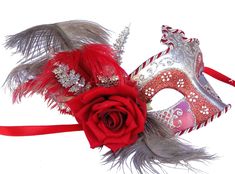 Beautiful red and silver masquerade mask hand decorated with red and silver glitter design and embellished with grey and red ostrich feathers, and a silk red rose. Ribbon ties. Hand made in Australia. Laura Lucci Collection Please note: there are delays in postage locally and all around the world. International Standard postage is now 15-20 business days International Express postage 10-20 business days. These are estimates only, it can take substantially longer, specially during peak times. Rose Masquerade Mask, Silver Masquerade Mask, Mens Masquerade Mask, Masquerade Masks, Costume Masks, Masks Masquerade, Rose Rouge, La Rose, Masquerade Mask