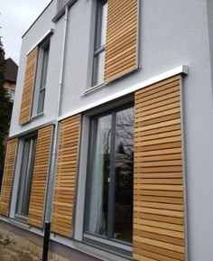 a house with wooden shutters on the windows