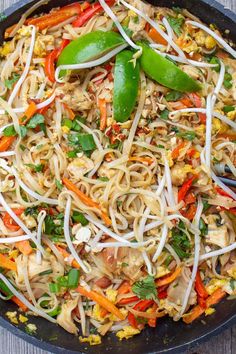 a skillet filled with noodles and vegetables