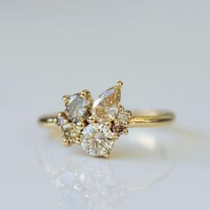 a yellow gold ring with three pear shaped diamonds