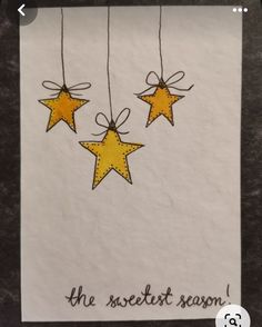 three yellow stars hanging from strings with the words, the sweetest season