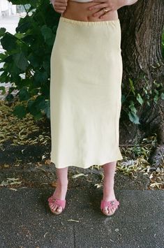 A bias cut midi skirt with an elasticated waist.    baserange    - sophie yellow  - 100% ecovero viscose  - fit is true to size  - ruby is 5'9" size 8 uk and is wearing a size s  - made in turkey    worn with baserange tav tank top Midi Skirts Style, Asymmetric Skirt, Asymmetrical Skirt, Fashion Line, Women Artisans, Womens Size Chart, Vintage Fabric, Vintage Silk, Designer Outfits Woman