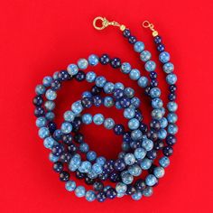 "52-Inch Blue Lapis and Denim Lapis Necklace with Golden Vermeil Diamond Chip Clasp – Stunning & Versatile" Elevate your style with this breathtaking 52-inch blue lapis and denim lapis necklace, a truly unique and versatile piece. The deep, rich hues of blue lapis blend beautifully with the softer, natural tones of denim lapis, creating a harmonious and eye-catching design. With its impressive length, this necklace offers endless styling possibilities—you can wrap, tie, or drape it to suit any o Blue Gemstone Beads Lariat Necklace, Blue Hand Knotted Jewelry For Gift, Blue Hand-knotted Jewelry For Gift, Blue Lariat Jewelry Hand-strung, Blue Hand Knotted Round Bead Necklaces, Blue Hand-knotted Round Bead Necklaces, Blue Hand-knotted Necklaces, Luxury Blue Single Strand Beaded Necklace, Luxury Adjustable Blue Necklace