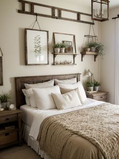 a bed with white linens and pillows in a bedroom next to two hanging planters