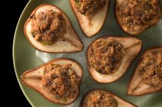 a green plate topped with stuffed potatoes covered in meat