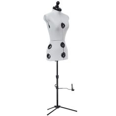 a white mannequin with black buttons on it's head and stand for display