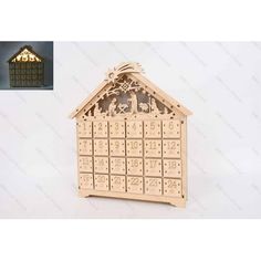 a wooden calendar with a nativity scene in the top and an image of a manger