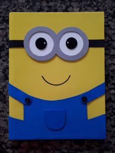 a yellow and blue minion with googly eyes on it's face is shown