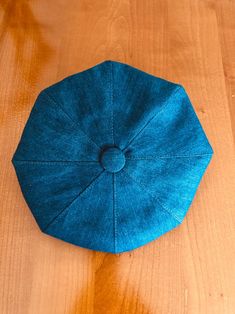 a blue hat sitting on top of a wooden table