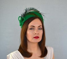 This is an exquisite emerald green velour felt headband with peacock feathers. The headband is blocked from luxurious velour felt using traditional millinery techniques and wooden hat forms. The headpiece is trimmed with peacock feathers and felt details.The headpiece fixes with a hat elastic at the back of the head.This lovely headpiece will be perfect for weddings, cocktail parties, Bachelorette Parties, Photo Shoots, races etc.--- * --- * --- * --- * ---This headpiece is READY FOR SHIPPING.-- Adjustable Green Headband Fascinator, Adjustable Green Mini Hat With Feathers, Green Feathered Headpiece For Weddings, Formal Green Headband Headpiece, Green Formal Headband, Formal Green Headband, Green Wedding Headband, Navy Fascinator, Green Fascinator