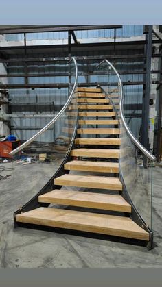 a set of wooden stairs with metal handrails