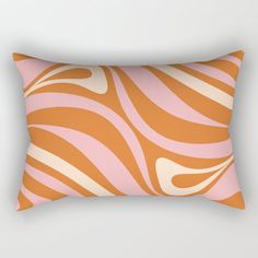 an orange and pink rectangular pillow with wavy lines on the front, along with a white background