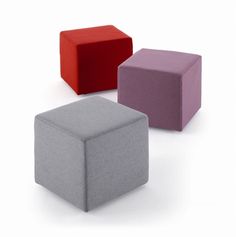 three different colored cubes sitting next to each other