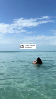 a woman is floating in the ocean with her head above the water's surface