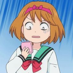 an anime character holding a cell phone in her right hand and looking at the camera