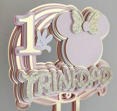 the first birthday cake topper is made out of fondant and has a minnie mouse on it