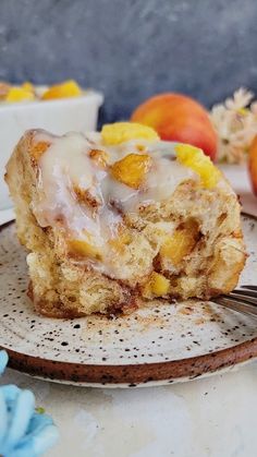 a piece of cake sitting on top of a plate next to a bowl of fruit